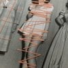 Embroidery art on black and white photo, threaded orange zig zag over woman