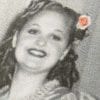 Embroidery art on black and white photo, threaded small orange flower in woman's hair