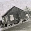 Embroidery art on black and white photo, repeating chain stitch sky in white above California home