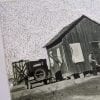 Embroidery art on black and white photo, repeating chain stitch sky in white above California home
