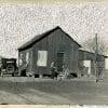 Embroidery art on black and white photo, repeating chain stitch sky in white above California home
