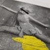 Embroidery Art, threaded yellow puddle on black and white photo of woman doing the splits