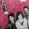 Embroidery art on black and white photo of family, threaded pink and red fuzzy wall