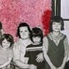 Embroidery art on black and white photo of family, threaded pink and red fuzzy wall