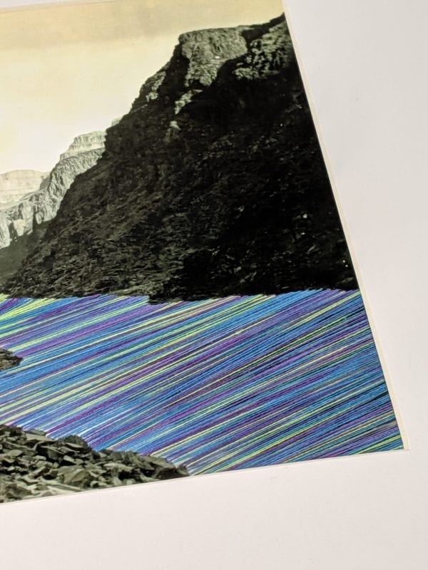 Embroidery Art, neon green purple and blue threaded river between mountains black and white photo