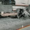 Embroidery Art, threaded lines on road of black and white photo of people fixing a car tire