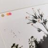 Embroidery art, neon circles and thread cigarettes on black and white photo