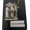 Pocket size black notebook with collage of two giraffes sticking their head out of a home